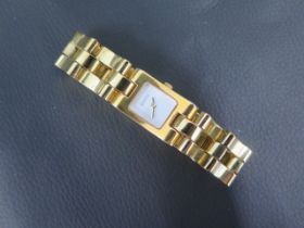 A ladies gold coloured Gucci quartz wristwatch, rectangular case approx 17mm x 29mm with box,