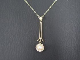 A 15ct yellow gold chain and drop pendant set with pearls and diamonds - central pearl surrounded by