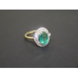 A good emerald and diamond cluster ring - The oval central emerald approx 2.2ct, surrounded by 38