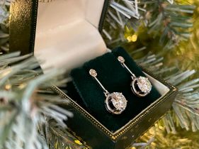 A superb pair of single stone diamond drop earrings - The round brilliant cut stones each