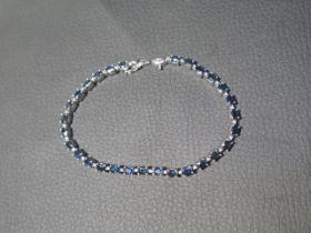 An 18ct white gold bracelet inset with sapphires - Length 18cm - in good condition - approx weight