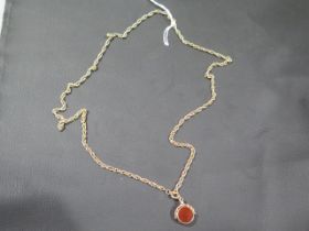 A 9ct rose gold swivel fob with carnelian bloodstone on a 9ct yellow gold chain - fob approx 1.