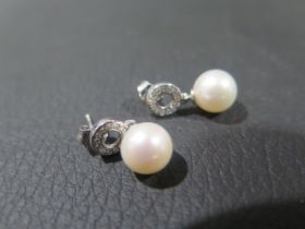 A pair of 9ct white gold pearl and diamond halo droplet earrings - rose cut diamonds approx 0.15ct -