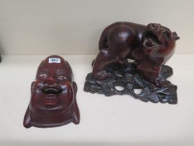 A Chinese carved wood figure of Tiger approx 19cm on matching carved wood stand together with a