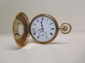 An 18ct gold pocket watch - in working order - with a second hand, hallmarked 18ct - the backplate