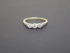 An 18ct yellow gold three stone diamond ring size O - weight approx 2.2 grams