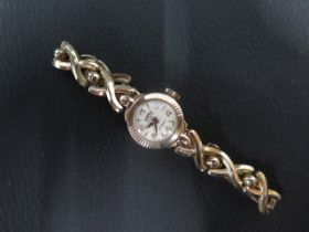 A 9ct yellow gold lady's Roamer wristwatch - 9ct gold case approx 16mm - with 9ct gold bracelet