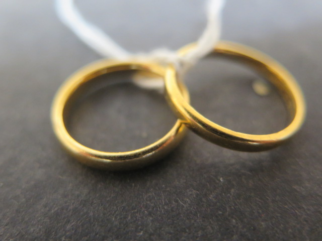 Two 22ct yellow gold wedding bands sizes N & K/L - combined weight approx 7.2 grams
