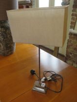 A chromium plated table lamp with shade