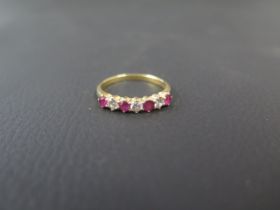 An 18ct yellow gold ruby and diamond bridge ring size Q/R - weight approx 3.3 grams