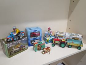 Assorted clockwork toys, all working and boxed and a boxed set of Corgi vans