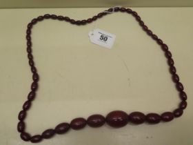 A cherry amber necklace - approx weight 70.2 grams - Length 78cm - gifted to the vendor by her