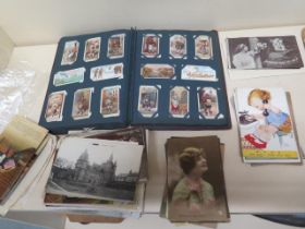 A collection of postcards and cigarette cards