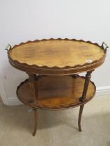 A yew veneer oval two tier occasional table