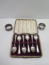 A set of silver spoons, Sheffield 1957, boxed with two silver napkin rings - total weight approx 2.6