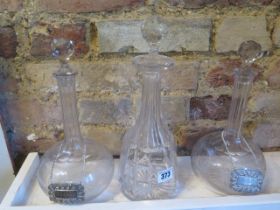 A pair of decanters and a single