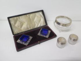 A pair of early Edwardian silver salts Birmingham 1902, square shaped with matching blue glass