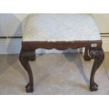 A mahogany stool on cabriole legs