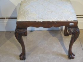 A mahogany stool on cabriole legs