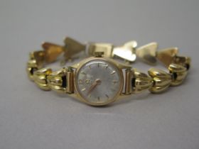 A ladies Omega rose gold (hallmarked) cased watch with yellow gold (tested) bracelet - not currently