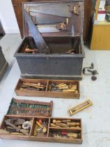 A 19th century pine carpenters toolbox with a good selection of tools including wood drill bits,