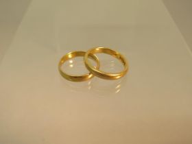 Two 22ct yellow gold (hallmarked) wedding bands ring size Q and O - total weight approx 9.2 grams