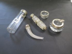 Five pieces of silver topped cut glass including a cornucopia bottle and hinged double bottle