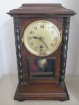 An oak 8 day striking mantle clock