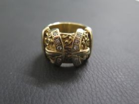 A large and impressive mans 9ct yellow gold buckle ring, twin central buckles set with diamonds,