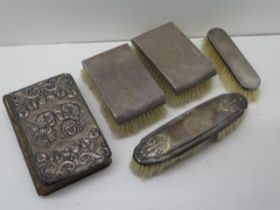 Four silver backed brushes and a silver backed Bible