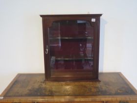 A mahogany single door table/mantle top glass display cabinet, two shelves, lock and key - approx