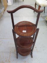 An Edwardian mahogany and inlaid folding cake stand