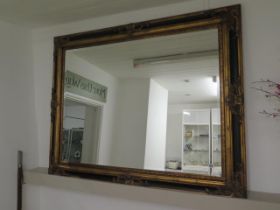 A modern mirror with a black and gold ornate frame and bevelled edge glass measuring 150cm x 117cm