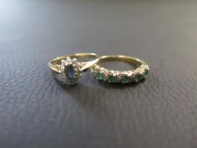 Two 9ct yellow gold rings - one with emerald and diamond, ring size L - the other with sapphires and