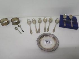 A silver dish, ten silver spoons and two silver napkin rings - Approx weight 4.8 troy oz