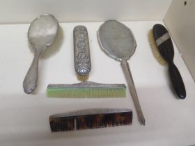 Six mixed silver mounted dressing table set items including mirror, three brushes and two combs