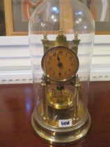 A brass Anniversary clock under a glass dome