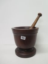 A large wooden pestle and mortar - mortar approx 22cm