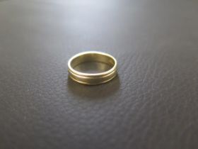 An 18ct yellow gold wedding band - ring size K - weight approx 3.4 grams