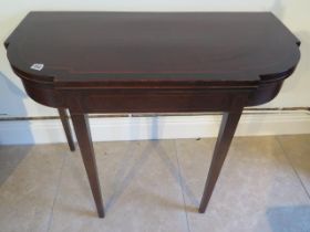 A 19th century mahogany and inlaid fold over card table on square tapering legs - Width 92cm