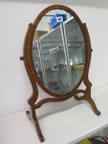 An Edwardian oval dressing mirror