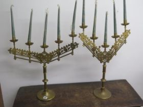 A matching pair of brass candle sticks both with height adjustment