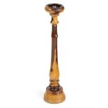 A TREEN LIGNUM VITAE FLOOR STANDING ASHTRAY 20TH CENTURY with a dished top and a baluster turned
