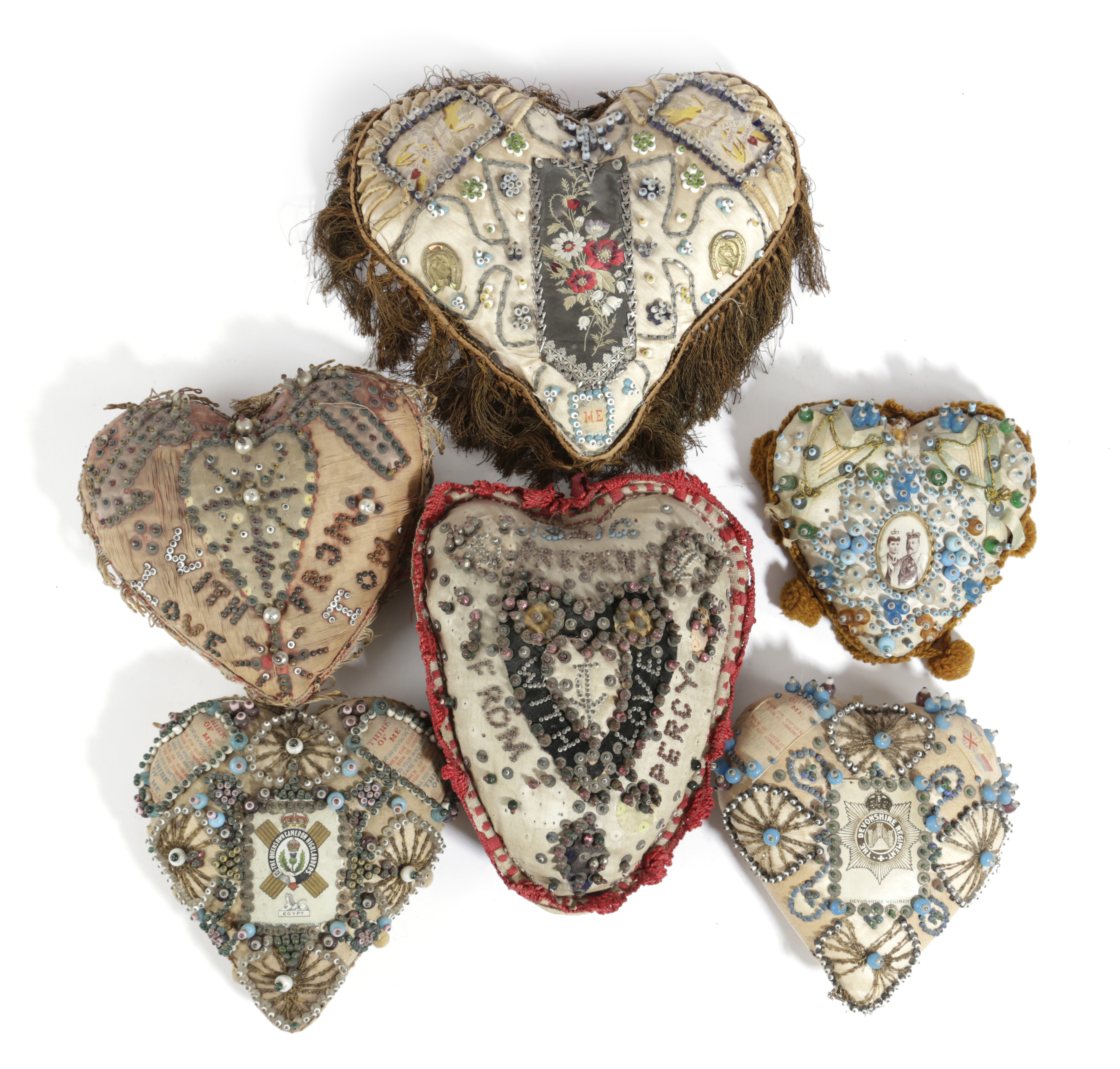 A COLLECTION OF SIX HEART-SHAPED SWEETHEART OR VALENTINE'S CUSHIONS LATE 19TH / EARLY 20TH CENTURY