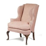 A GEORGE II WALNUT WING ARMCHAIR C.1730-40 later upholstered, with scroll arms on cabriole front