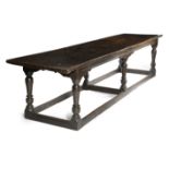 AN OAK REFECTORY TABLE MID-17TH CENTURY AND LATER the boarded top with cleated ends above a