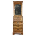 A WALNUT BUREAU BOOKCASE IN GEORGE I STYLE, 18TH CENTURY ELEMENTS AND LATER with cross and feather