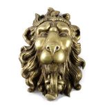 A GILTWOOD LION'S MASK 20TH CENTURY carved with an open mouth and a flowing mane 54cm high, 41cm