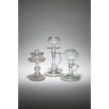 THREE GLASS LACE MAKER'S LAMPS 19TH / 20TH CENTURY two with loop handles and circular feet, the