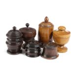 SIX TREEN JARS AND COVERS 19TH CENTURY AND LATER in various woods including: lignum vitae and